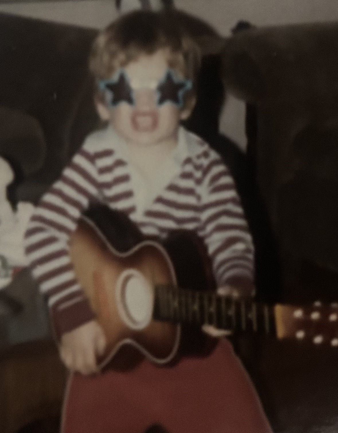 Trio founder as a child with a guitar